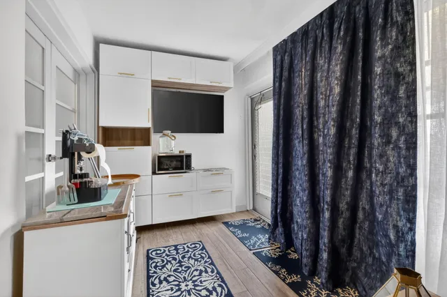 a room with a television and a stove top oven
