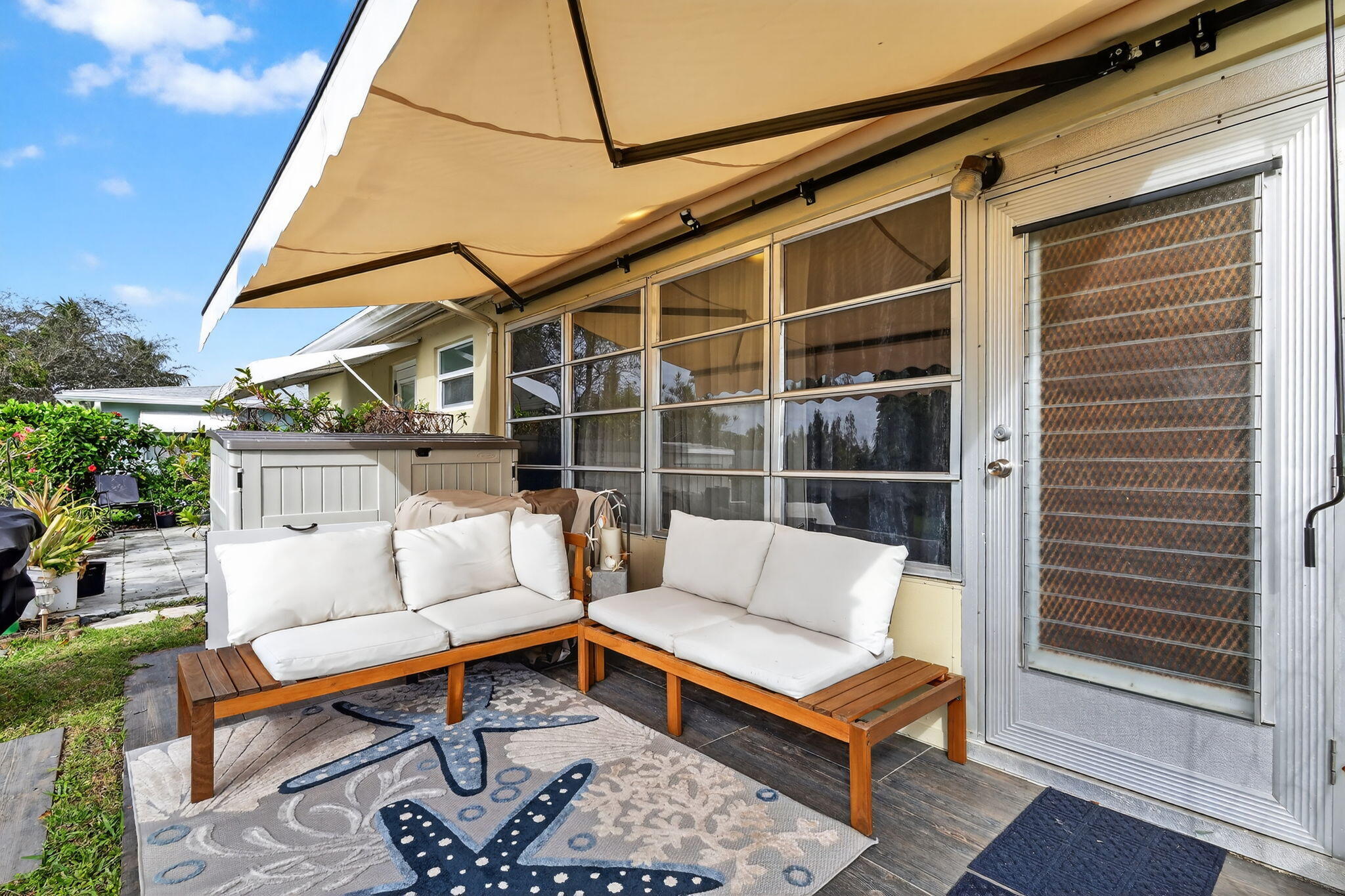 212 West High Point Terrace, Unit C Delray Beach, FL 33445 - Photo 33 of 35 a outdoor living space with furniture and a rug