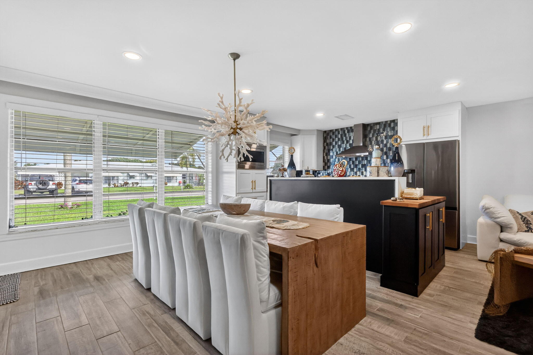 212 West High Point Terrace, Unit C Delray Beach, FL 33445 - Photo 4 of 35 a living room with stainless steel appliances kitchen island granite countertop a refrigerator a sink a stove and a wooden floors