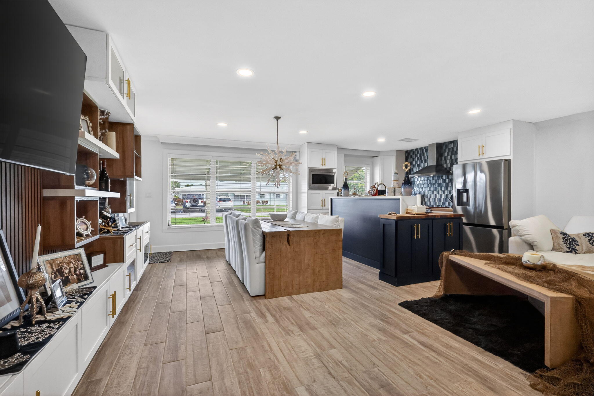 212 West High Point Terrace, Unit C Delray Beach, FL 33445 - Photo 9 of 35 a kitchen with stainless steel appliances kitchen island granite countertop a refrigerator a sink a stove and a wooden floors
