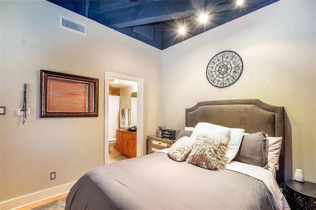 910 Houston Street, Unit 604 Fort Worth, TX 76102 - Photo 12 of 14 Bedroom with baseboards and ensuite bathroom
