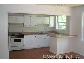 100 Union Chapel Road Weaverville, NC 28787 - Photo 3 of 12 a kitchen with granite countertop white cabinets and white appliances