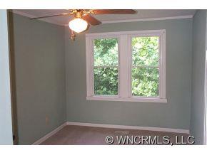 100 Union Chapel Road Weaverville, NC 28787 - Photo 5 of 12 a view of an empty room with wooden floor and a window