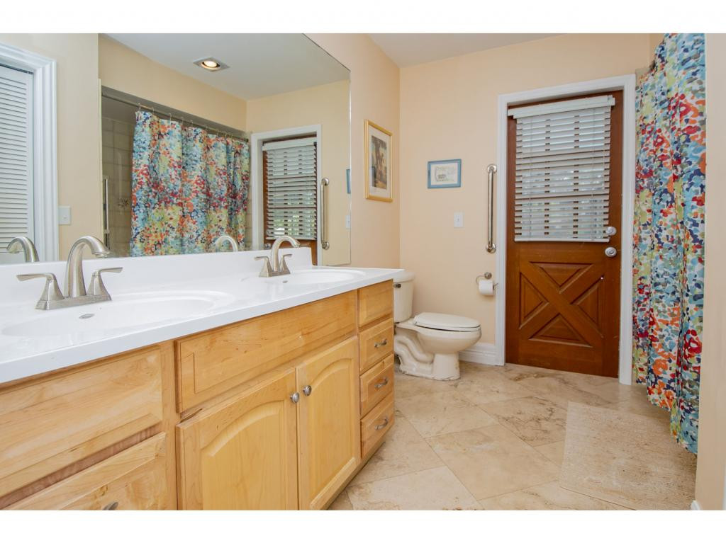 4125 13th Avenue Southwest Naples, FL 34116 - Photo 12 of 34 a spacious bathroom with a sink a toilet a shower and a window