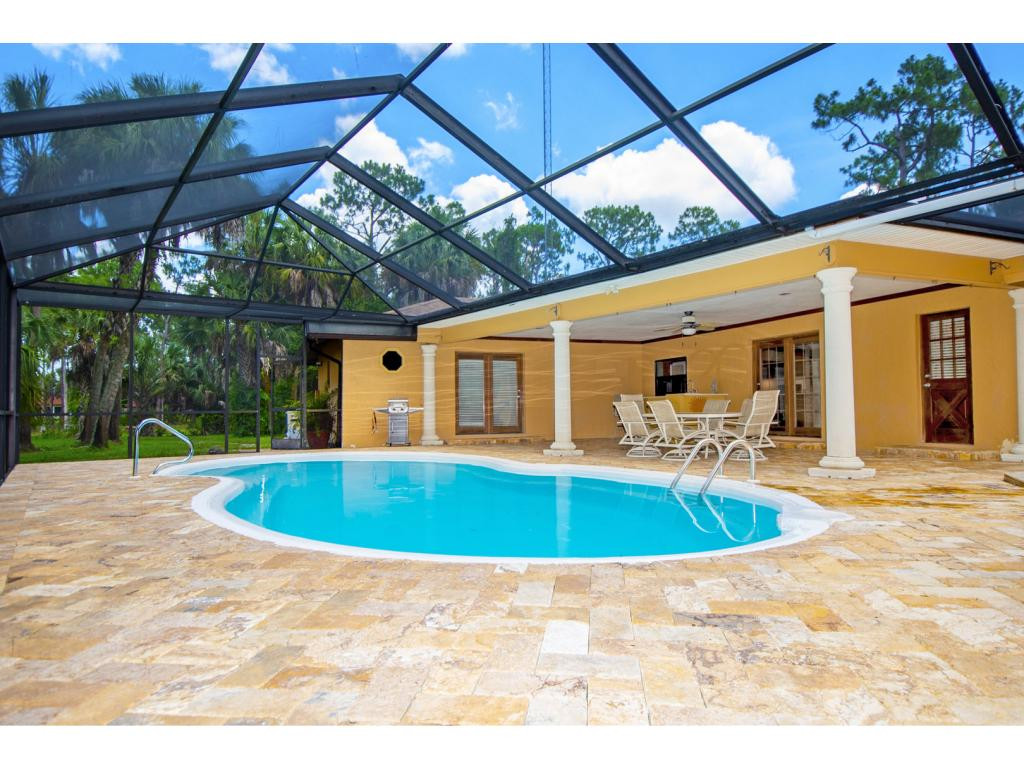 4125 13th Avenue Southwest Naples, FL 34116 - Photo 13 of 34 a view of outdoor space yard swimming pool and outdoor seating