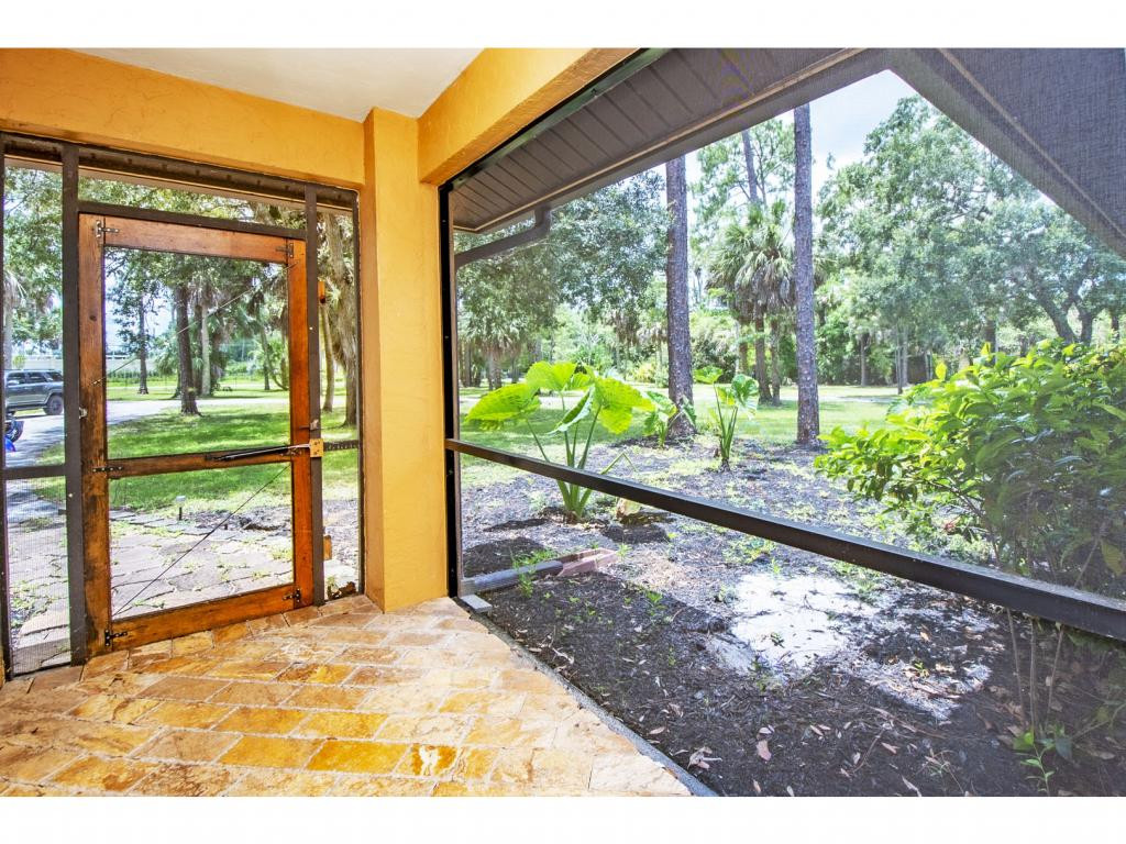 4125 13th Avenue Southwest Naples, FL 34116 - Photo 16 of 34 a view of a porch and a yard