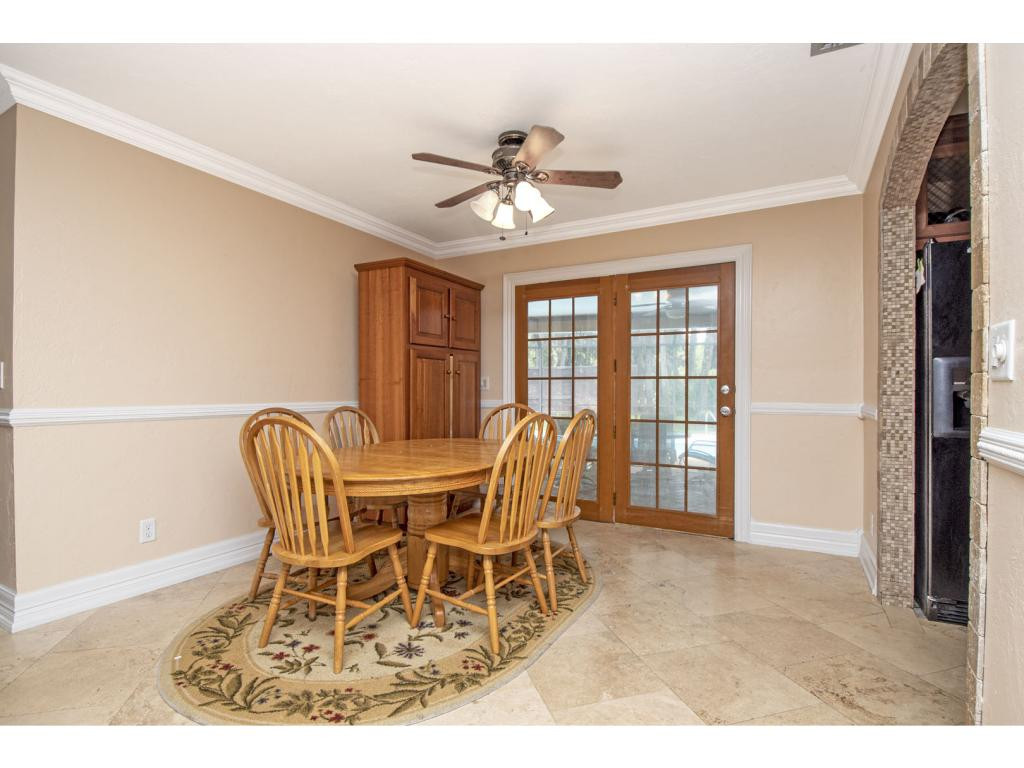 4125 13th Avenue Southwest Naples, FL 34116 - Photo 3 of 34 a dining room with furniture and chandelier fan