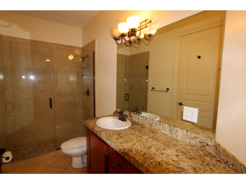 4125 13th Avenue Southwest Naples, FL 34116 - Photo 27 of 34 a bathroom with a granite countertop sink toilet and shower