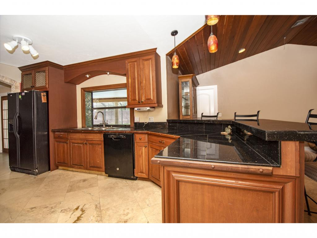 4125 13th Avenue Southwest Naples, FL 34116 - Photo 4 of 34 a kitchen with a refrigerator and a sink