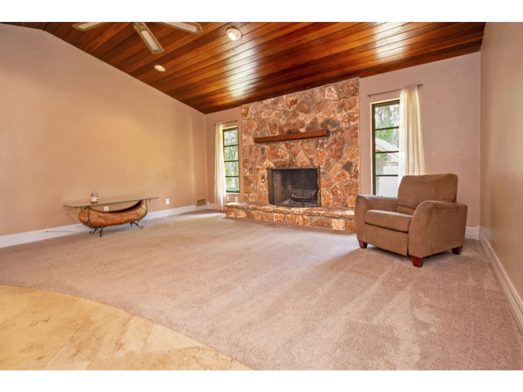 4125 13th Avenue Southwest Naples, FL 34116 - Photo 7 of 34 a living room with furniture and a fireplace