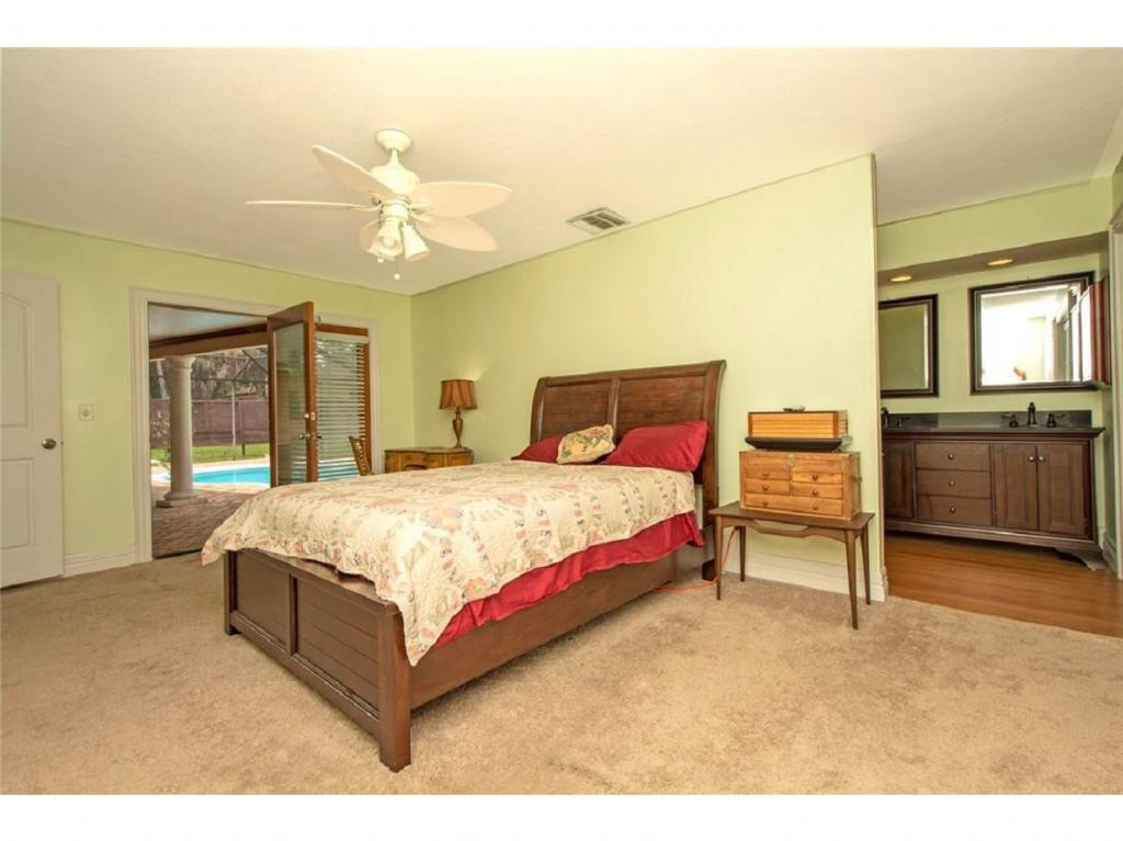 4125 13th Avenue Southwest Naples, FL 34116 - Photo 8 of 34 a bedroom with a bed dresser and a table