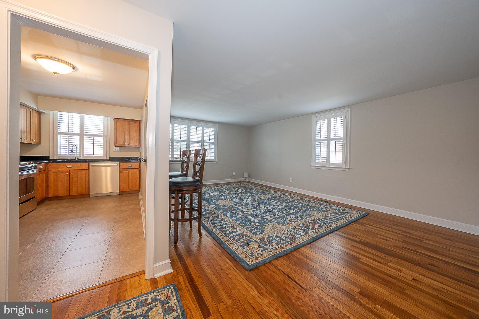 500 East Lancaster Avenue, Unit 111A Wayne, PA 19087 - Photo 12 of 43 a living room with kitchen view and a table