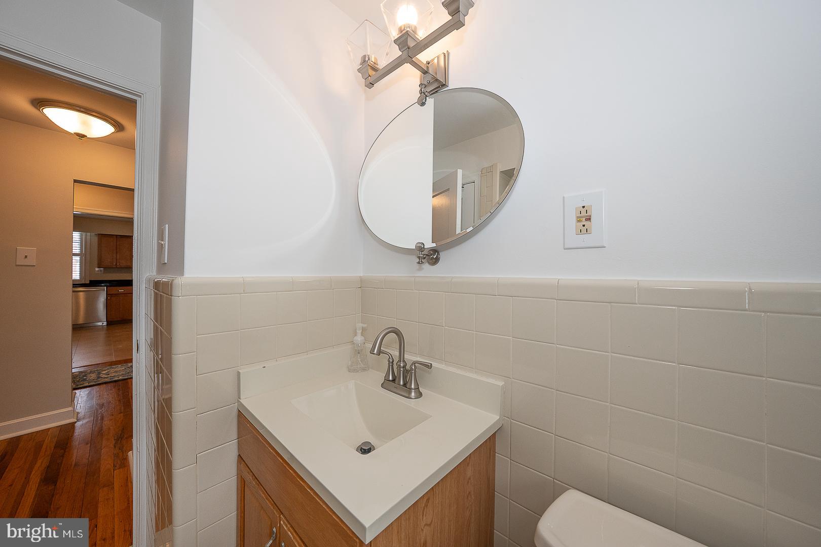 500 East Lancaster Avenue, Unit 111A Wayne, PA 19087 - Photo 25 of 43 a bathroom with a sink mirror and toilet