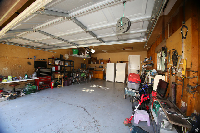 1612 East 450 South Springville, UT 84663 - Photo 21 of 48 Spacious garage featuring a concrete floor, overhead garage door with track system, and an interior access door