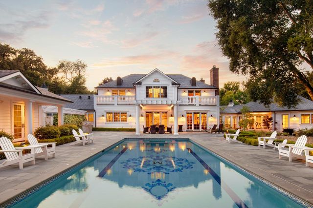 a swimming pool view with a outdoor seating space