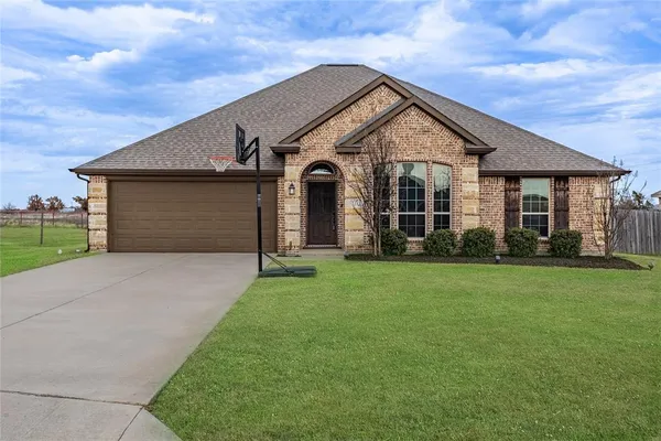 a front view of house with yard and green space