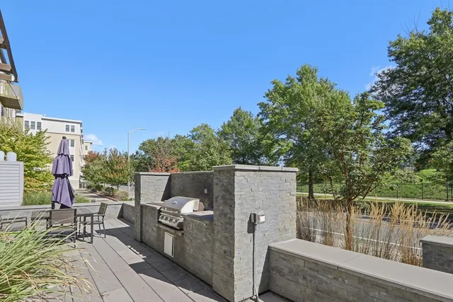a view of a patio with table and chairs with wooden fence and floor