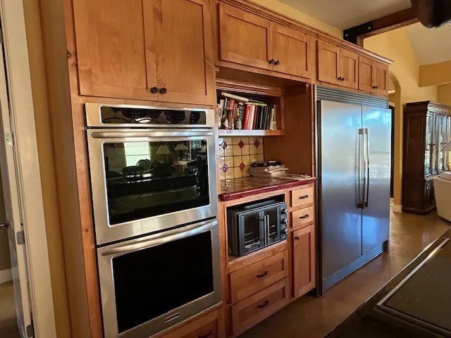 a view of a refrigerator and a stove