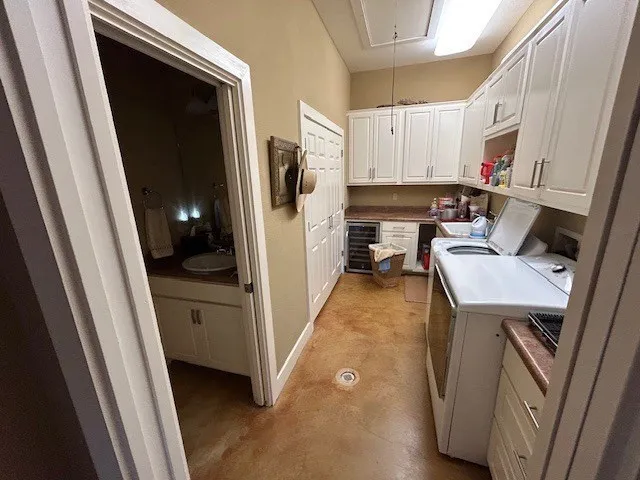 a spacious bedroom with a bed a couch and large windows