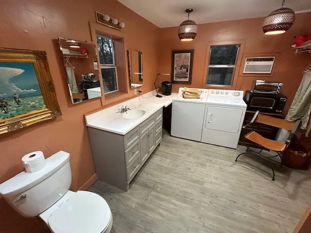 a room with furniture a window and a dresser