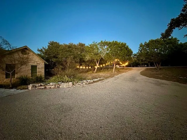 a living room with fireplace furniture and a large window