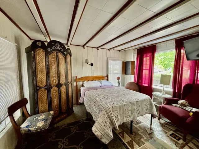 a bed room with a bed and a mirror