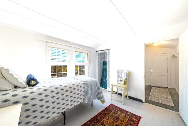 a bed room with a bed and a chair