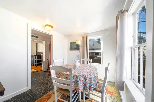 a dining room with furniture and a window