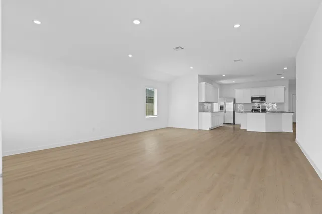 a view of a kitchen with a sink and a refrigerator