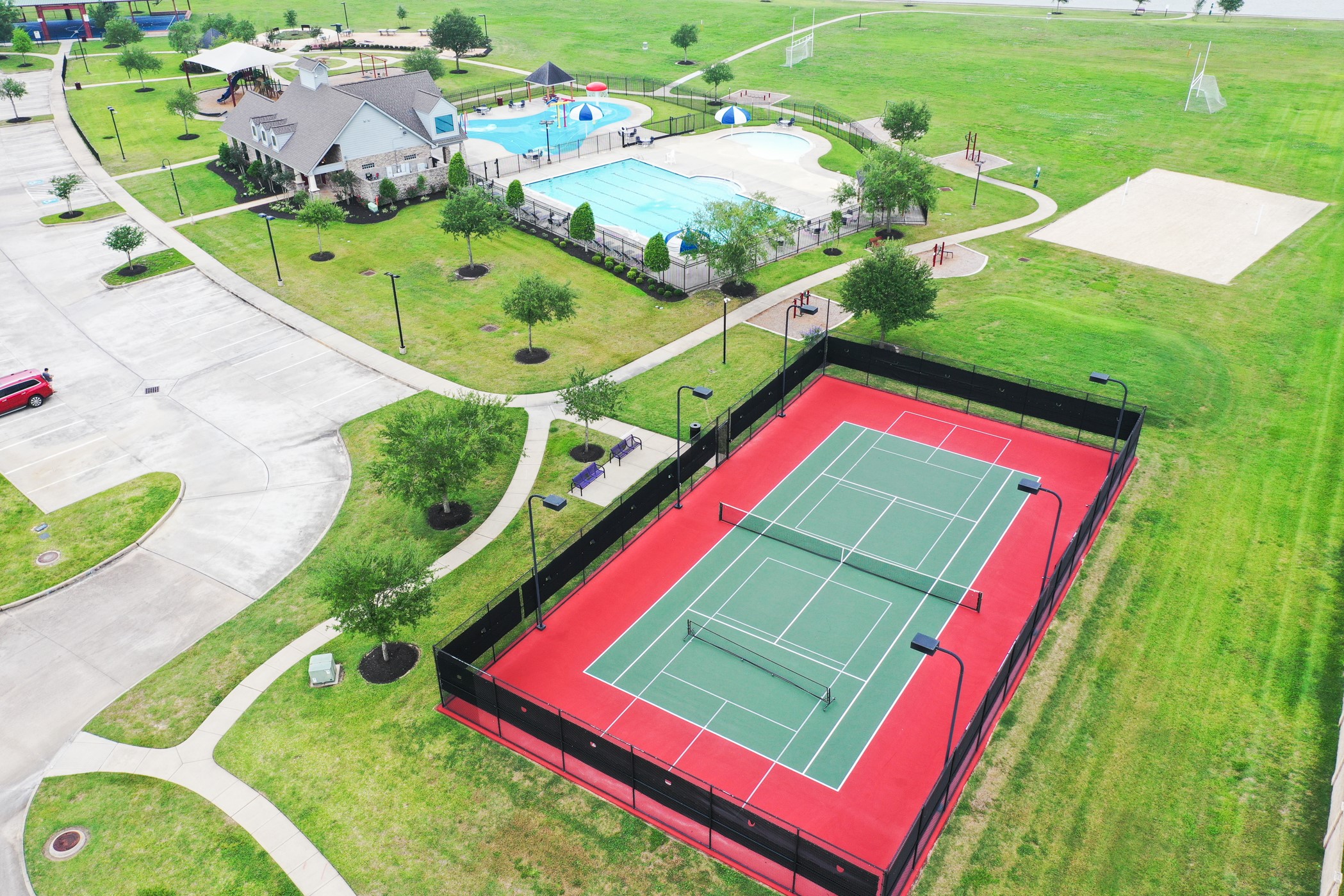 9438 Emerald Lakes Drive Rosharon, TX 77583 - Photo 30 of 36 a view of a tennis ground with a swimming pool