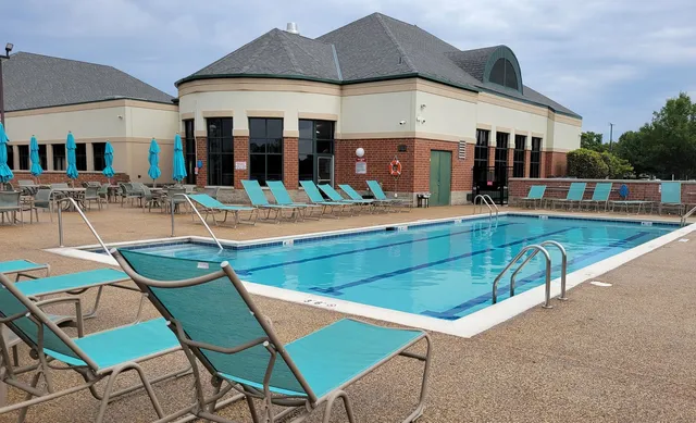a view of a patio with a table and chairs under an umbrella