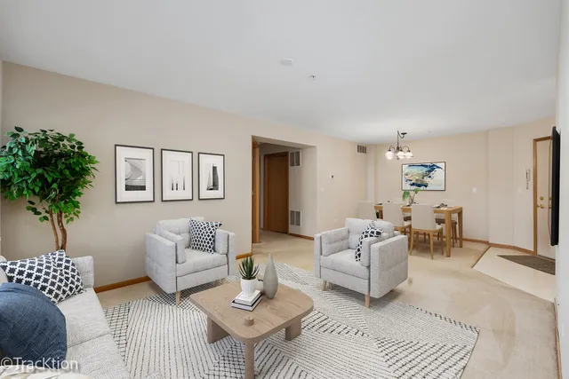 a living room with furniture and a potted plant
