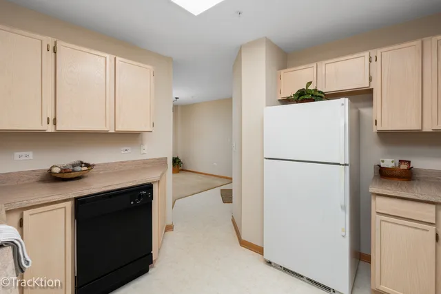 a kitchen with a refrigerator sink stove and cabinets
