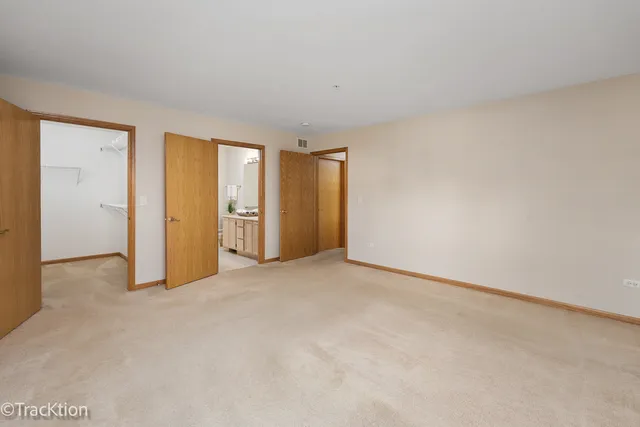 an empty room with a cabinet and mirrors