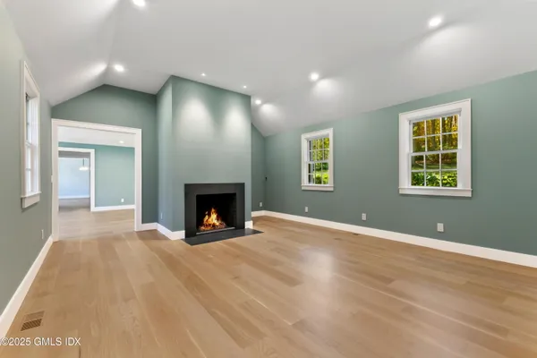 a view of an empty room with a fireplace and a window