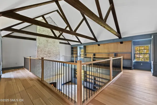 a view of a hallway with wooden staircase