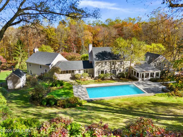 a view of a house with swimming pool and sitting area