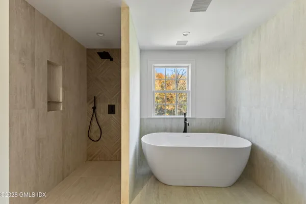 a bathroom with a bathtub and shower