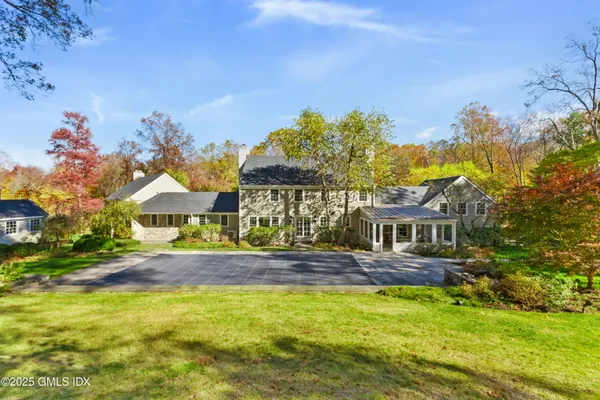 a front view of a house with a big yard