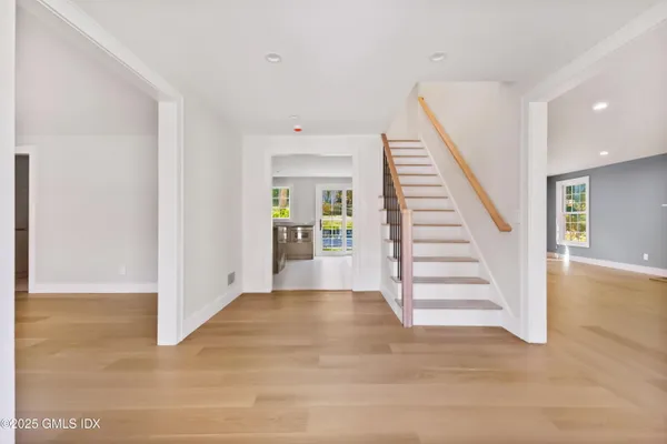 a view of entryway with wooden floor and stairs