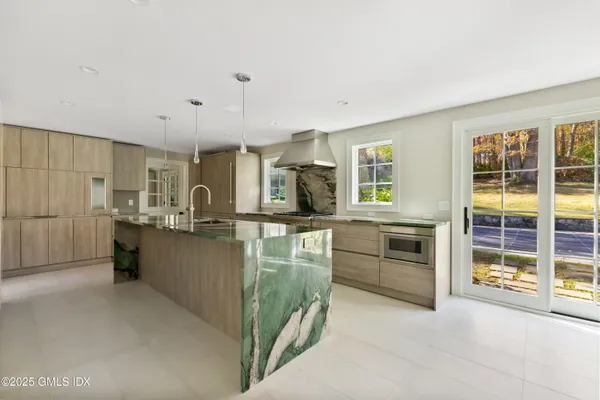 a kitchen with granite countertop a sink and counter top space