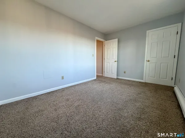 a view of an empty room and closet