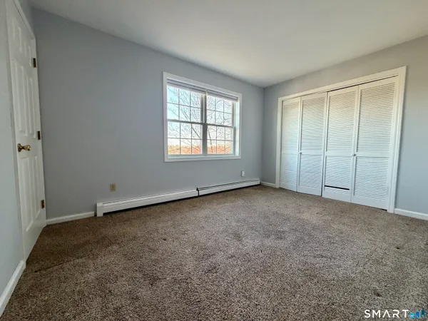 an empty room with a empty space and windows