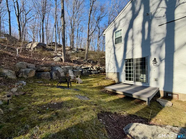 a backyard of residential house with outdoor seating