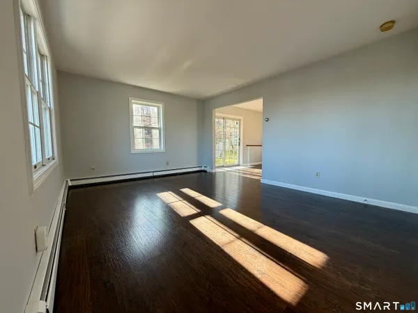 a view of room with window and wooden floor
