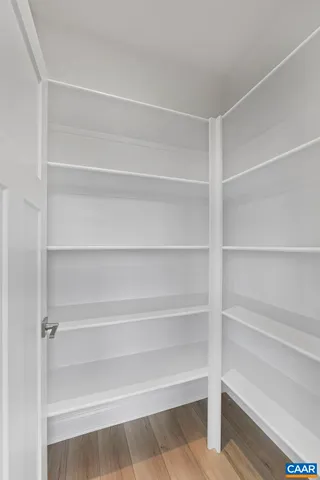 a view of walk in closet with empty racks