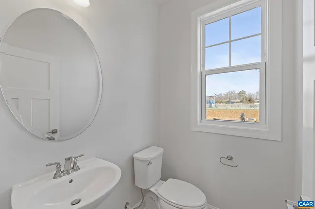 a bathroom with a sink mirror and toilet