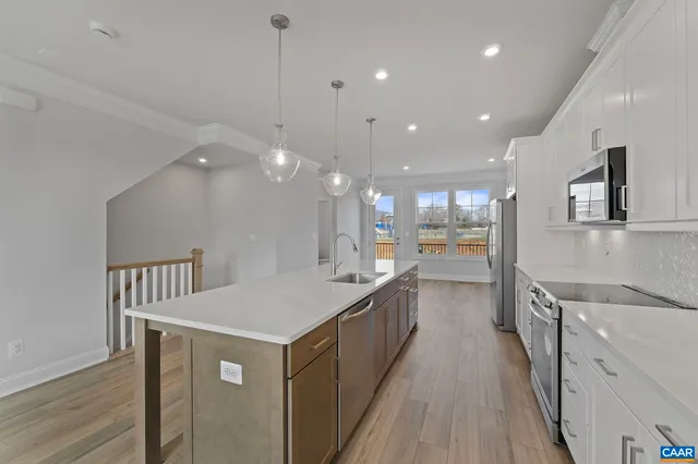 a kitchen with counter top space and wooden floor