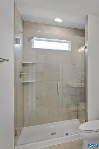 a bathroom with a shower and a toilet