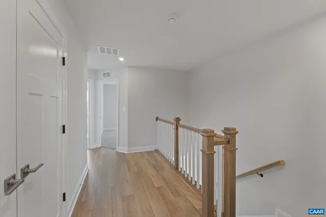 a view of a hallway with a wooden floor